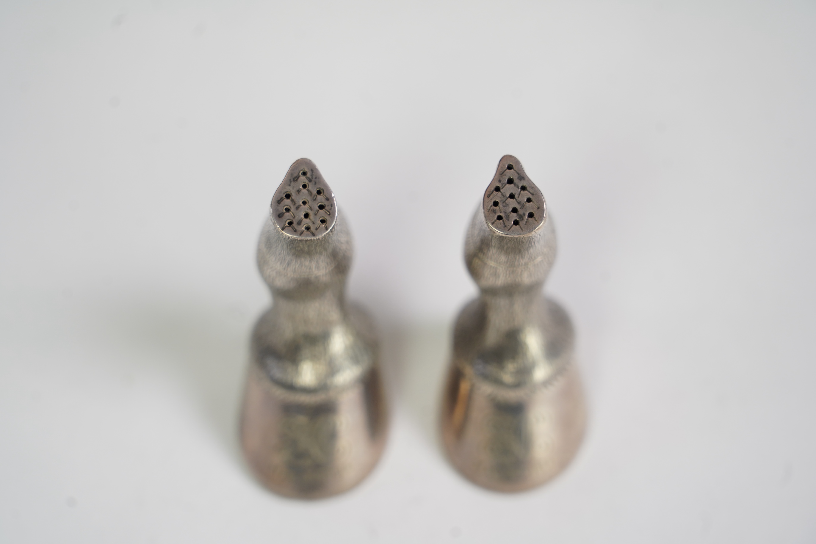 A pair of Edwardian novelty silver condiments modelled and a horse's fetlock and hoof, makers mark rubbed